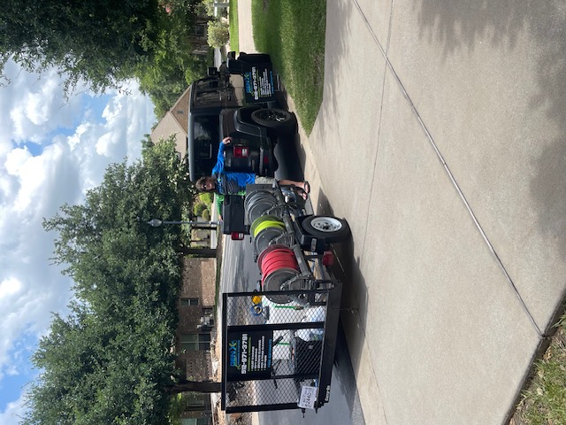 Duane Miller with his arms resting on the Gen X Pressure Washing Trailer